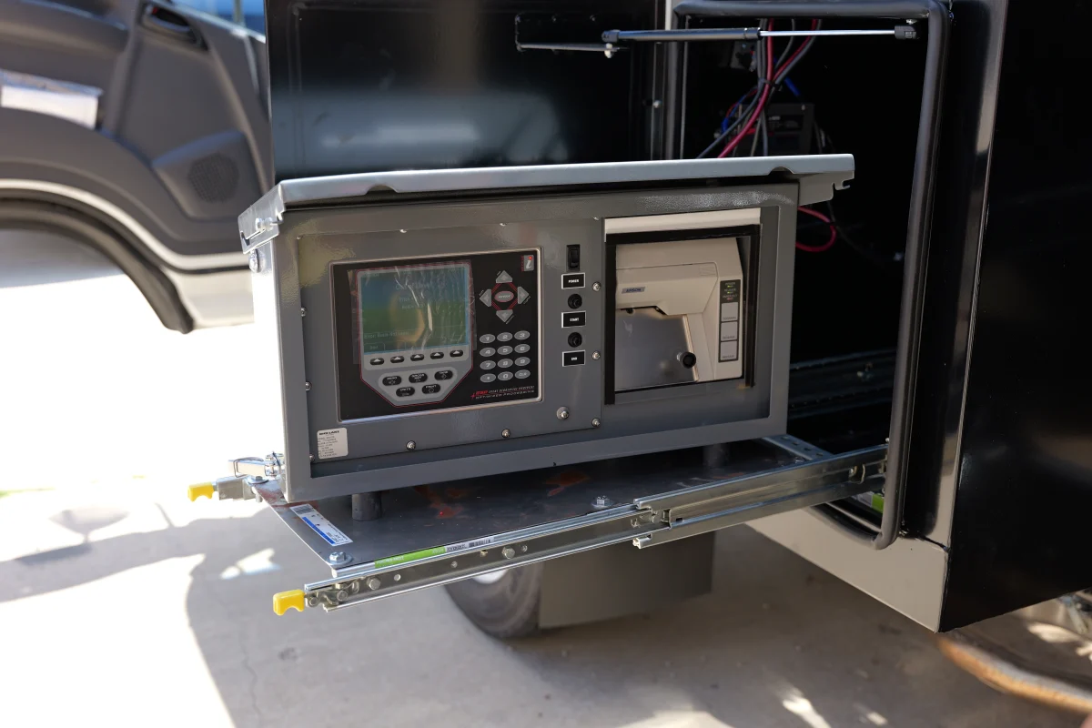 A Rice Lake mobile scale control panel and printer extends from a vehicle's side compartment.